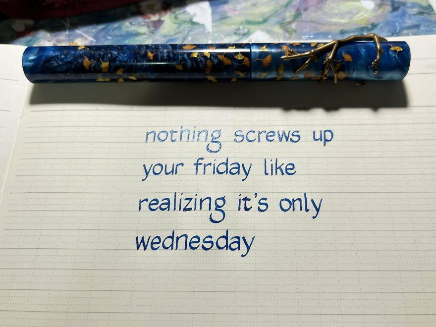 Neatly handwritten quote about Friday and Wednesday on lined paper with a blue and gold decorative pen above it.