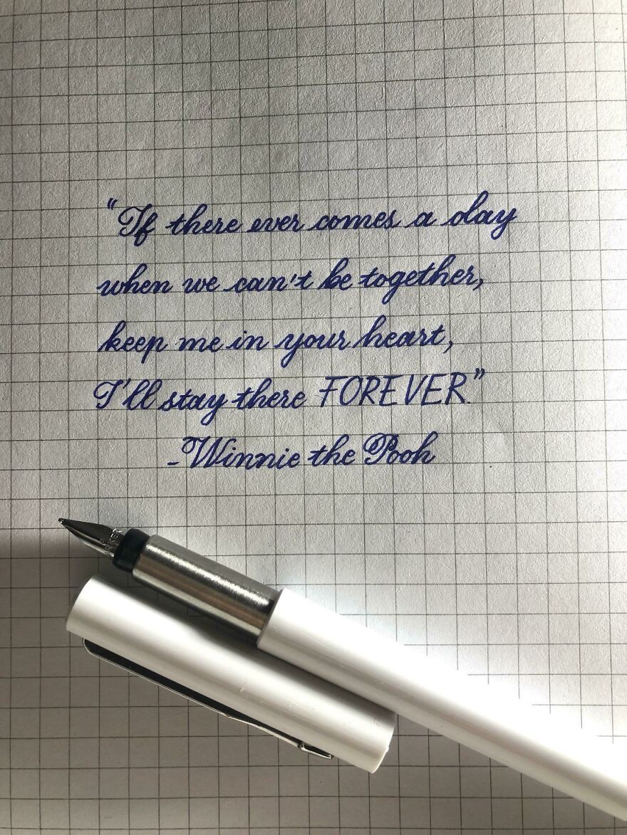 Handwritten Winnie the Pooh quote on grid paper with a white fountain pen, showcasing perfect handwriting examples.