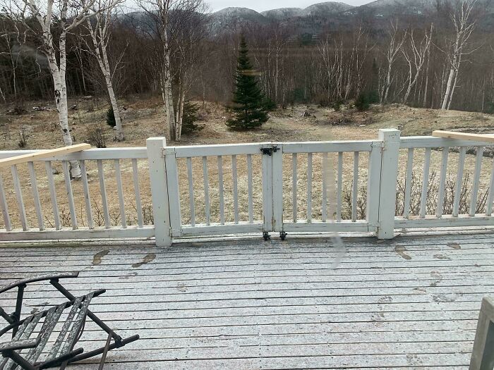 Wooden deck with a locked gate in open position and scattered snow, illustrating clueless partner mishap outdoors.