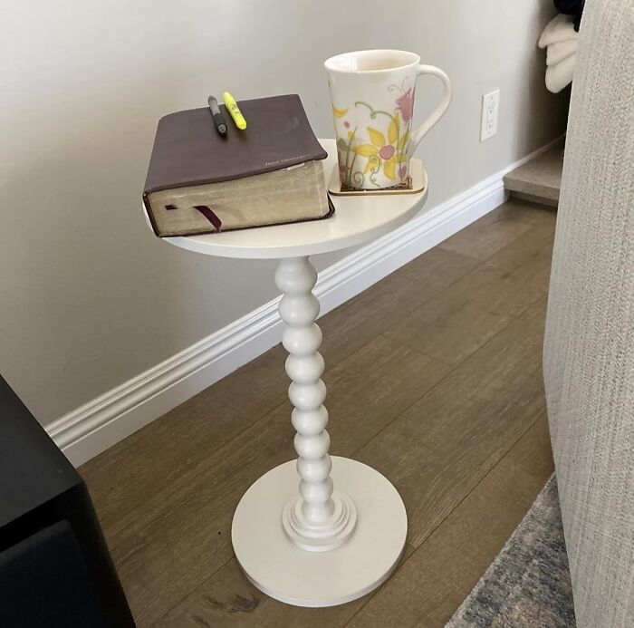 White side table with decorative beaded leg holding a floral mug and a closed book, ideal for Prime Day home deals.