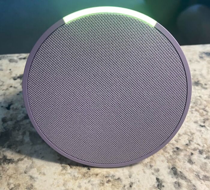 Portable wireless speaker on granite countertop with Prime Day deals under $25 to keep your bank account safe.