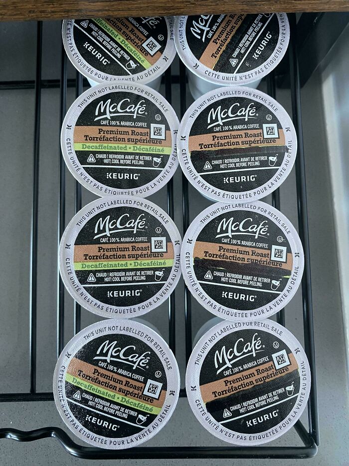 Multiple McCafe Keurig coffee pods arranged in a drawer, illustrating clueless partner's coffee organization fail.