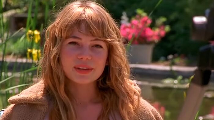 Young woman with long blonde hair in an outdoor garden setting representing tragic losses in TV show history.