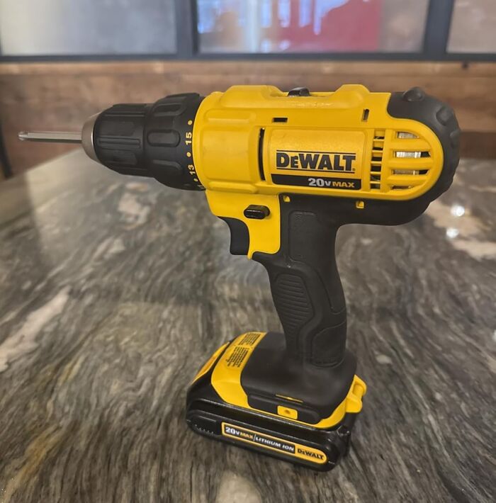 Yellow and black DeWalt 20V Max cordless drill featured among top Prime Day deals on a marble surface.