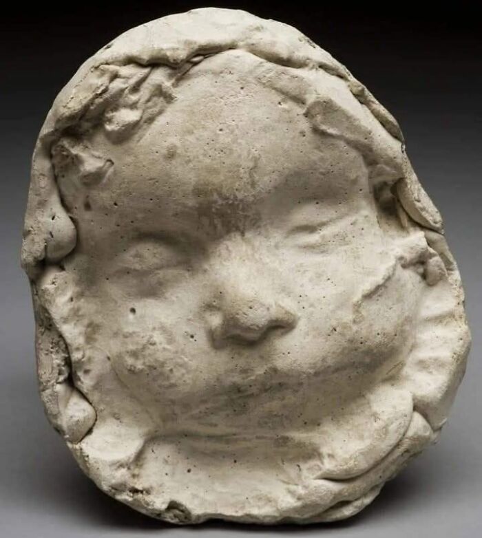 Plaster cast of a child's face, showcasing a fascinating historical photo artifact with detailed facial features.