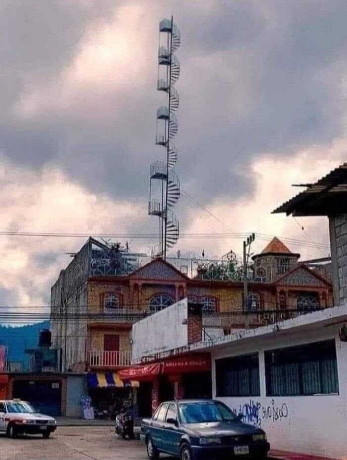Spiral staircase extending dangerously high above a building in Mexico, illustrating an extreme death stairs example.