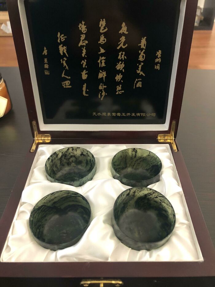 Set of four polished stone cups in a luxury box with Chinese calligraphy, symbolizing amazing luck and rare fortune.