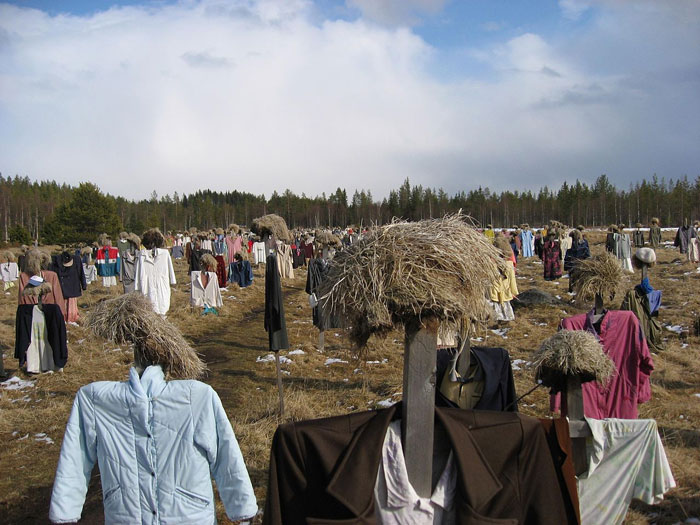 Field filled with scarecrow-like figures dressed in old clothes, one of the scariest places around the world for brave travelers