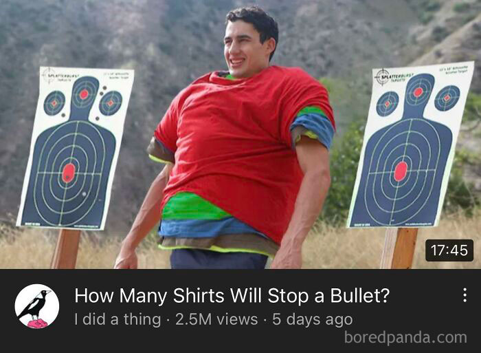 Man wearing multiple shirts standing between two shooting targets demonstrating dumb things men do outdoors.