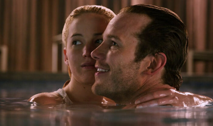 Couple embracing in a pool, illustrating romantic but toxic relationship scenes from popular movies.