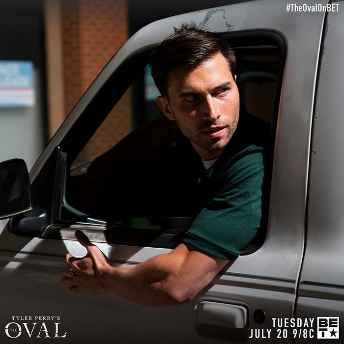 Male actor leaning out of a vehicle window in a scene from Tyler Perry's The Oval addressing harassment allegations.