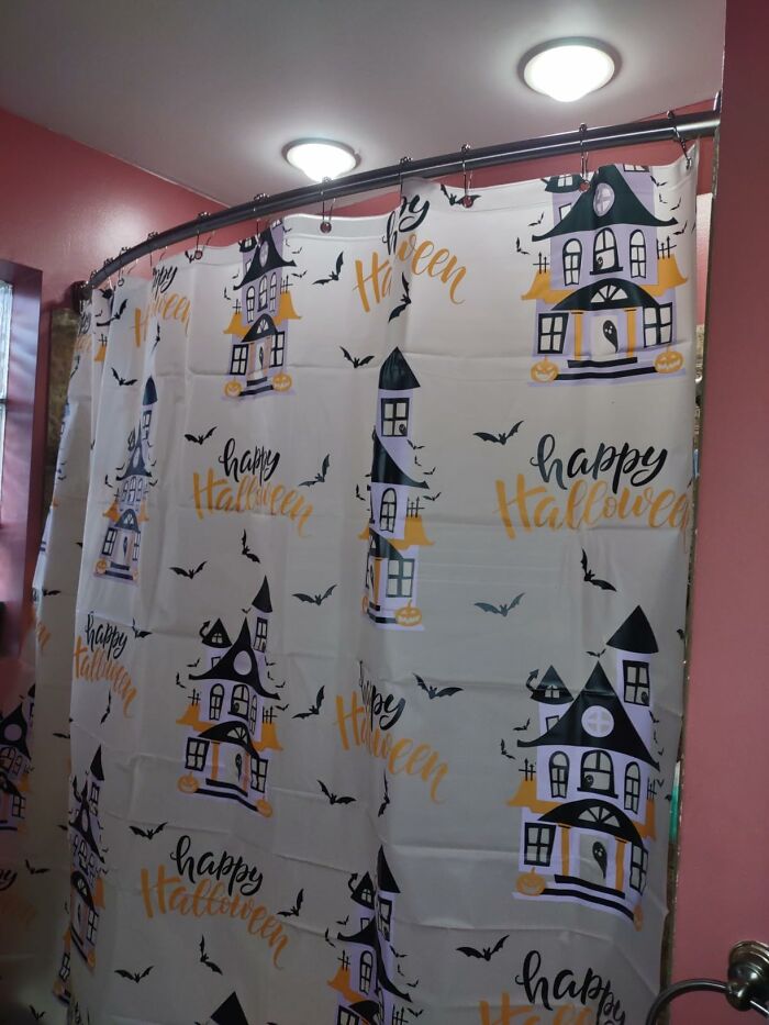 Halloween-themed shower curtain with haunted house and bats, an affordable everyday item under $300 improving home decor.