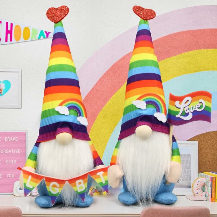 Two gnome decorations with rainbow hats and pride flags celebrating LGBTQ Pride pieces for all year.
