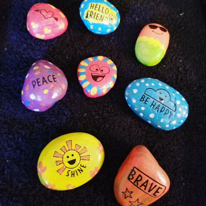 Colorful painted rocks with positive messages and smiley faces, a creative gift idea for shopping for a 12-year-old.