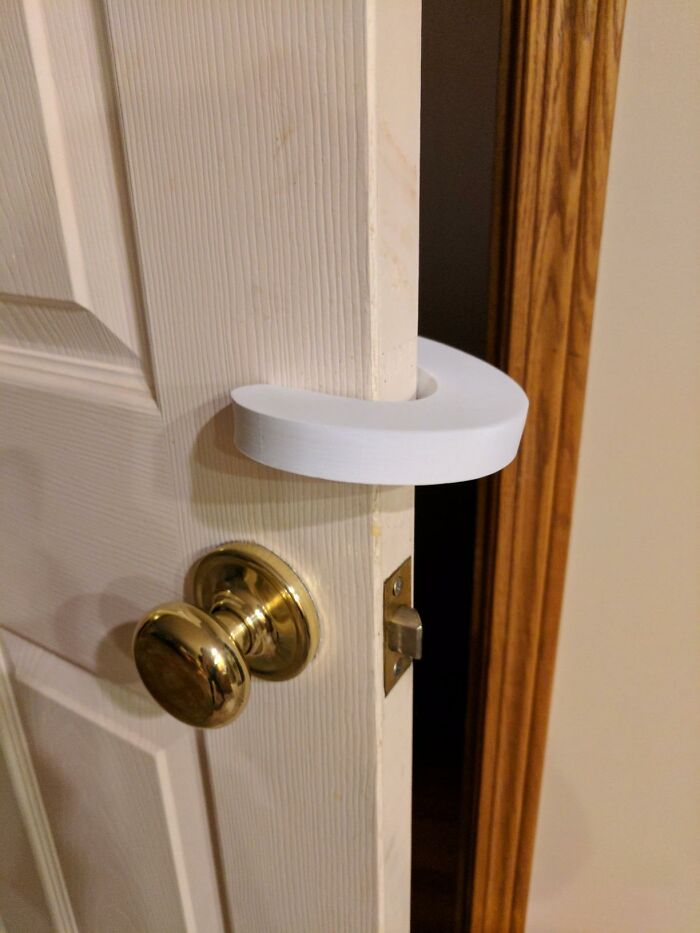 Door secured with a white plastic door lock device as a practical executive order find for home safety.