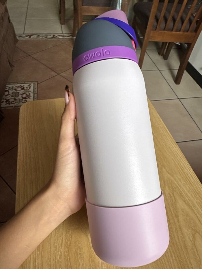Hand holding a white and purple Owala water bottle, one of the top finds for a first executive order.