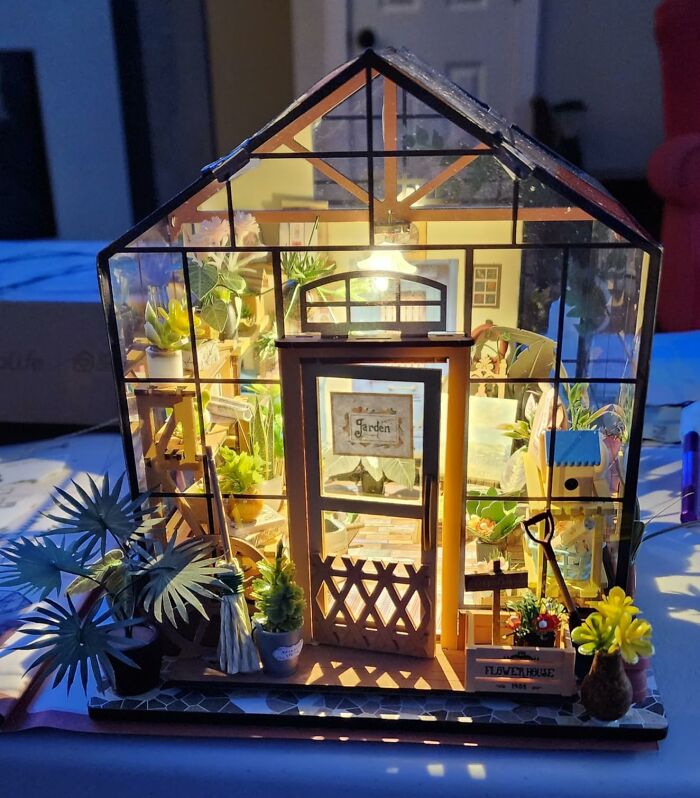 Miniature illuminated greenhouse craft kit featuring detailed plants and decor, perfect for creative crafting projects at home.