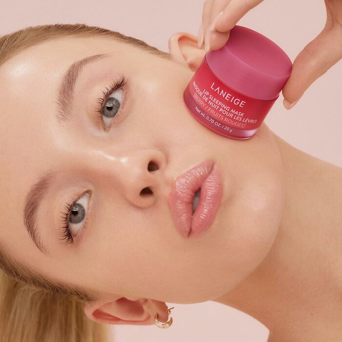 Close-up of woman holding a skincare product showcasing affordable Prime Day deals under $25 to keep your bank account safe.