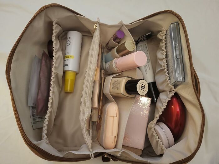Organized makeup and skincare products inside a beige travel pouch, popular Amazon wishlist finds for beauty and personal care.