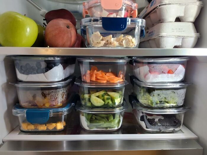 Organized fridge with fresh fruits and vegetables in containers, highlighting budget-friendly deals under $25 to save your bank account.
