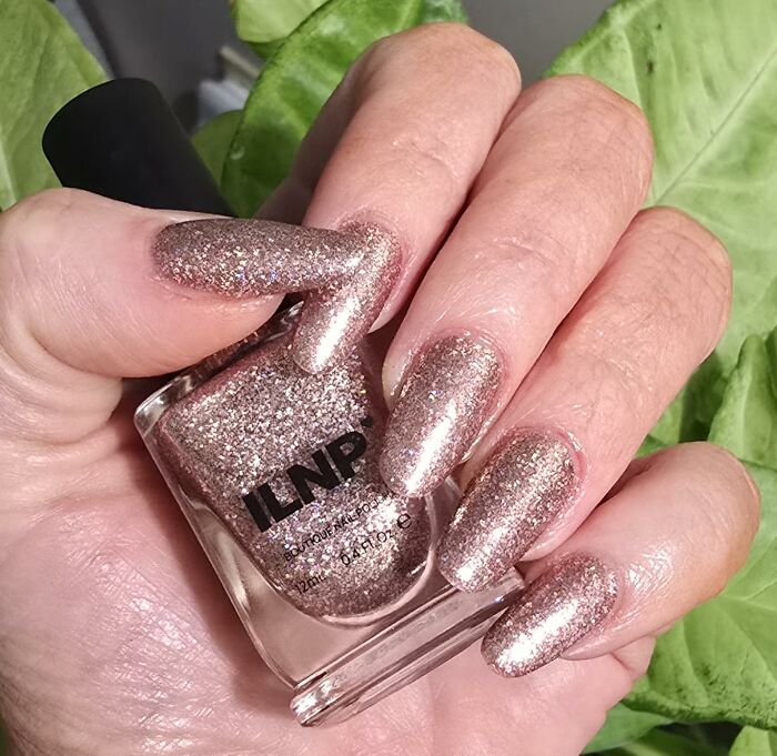 Glittery rose gold nail polish on manicured nails featured in popular Amazon wishlist finds.