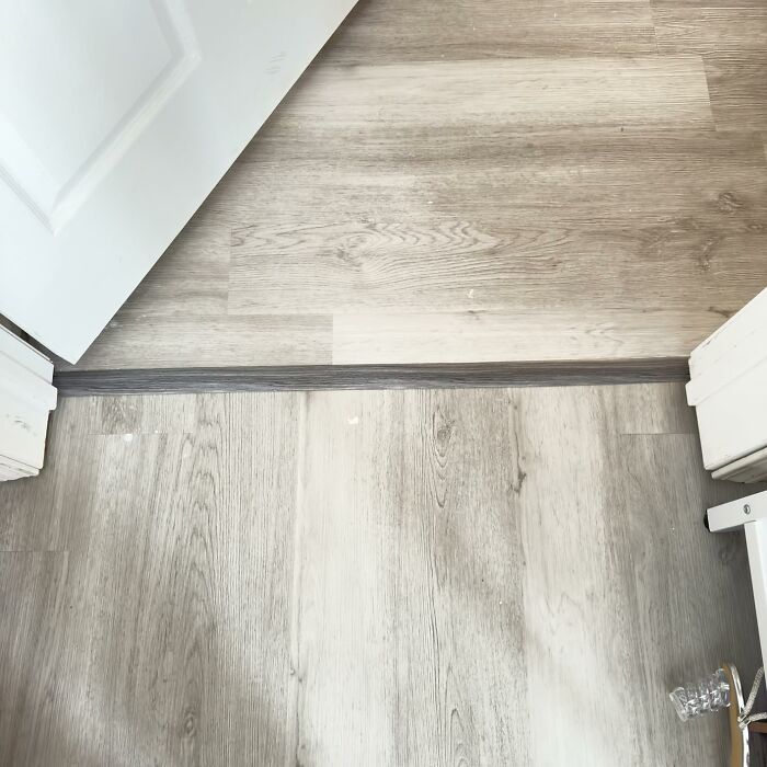 Close-up of a home flooring transition strip used for hiding home uglies between two rooms with different floors.