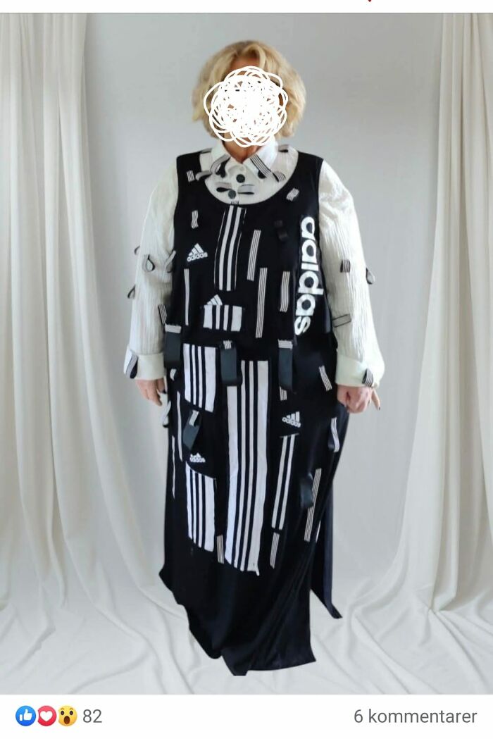 Person wearing a DIY craft shaming outfit made of black and white Adidas fabric scraps with visible tags and patches.