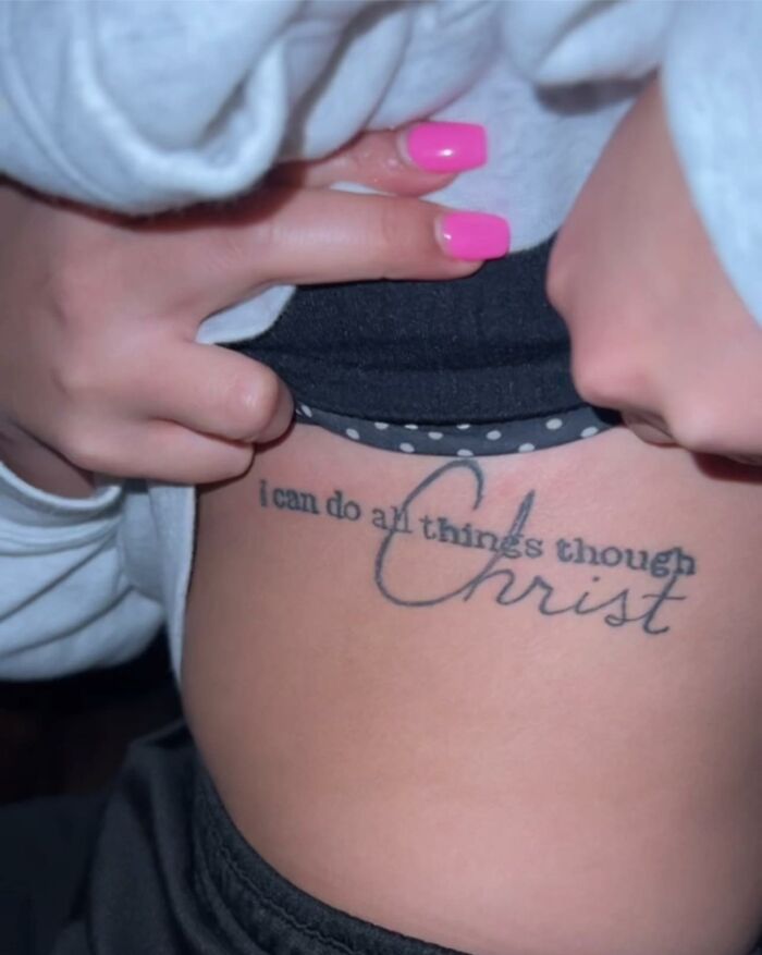 Tattoo with misspelled phrase inkshaming a badly done inspirational quote on a person's side rib area.
