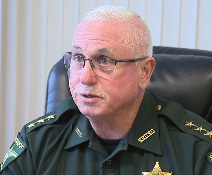 Law enforcement officer in uniform discussing captive woman&rsquo;s brave cry for help hidden in Jersey Mike&rsquo;s subs restroom.