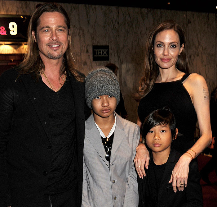 Brad Pitt with two sons and Angelina Jolie at an event, highlighting Brad Pitt cut off contact with sons news.