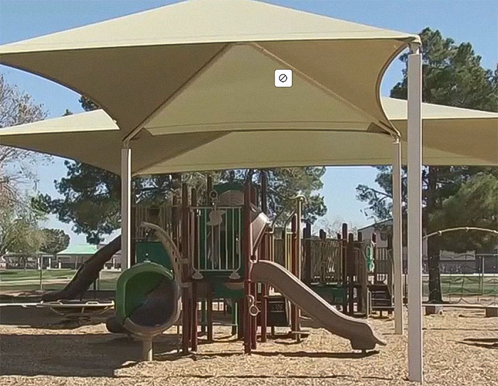 Playground area with slides and shade structures, related to raging mom driving pickup truck through kids park incident.