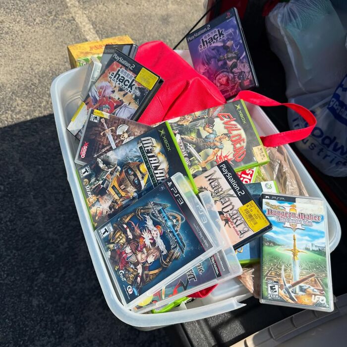 Basket of cool secondhand video games for PlayStation, Xbox, and PSP found at a thrift sale or garage sale.