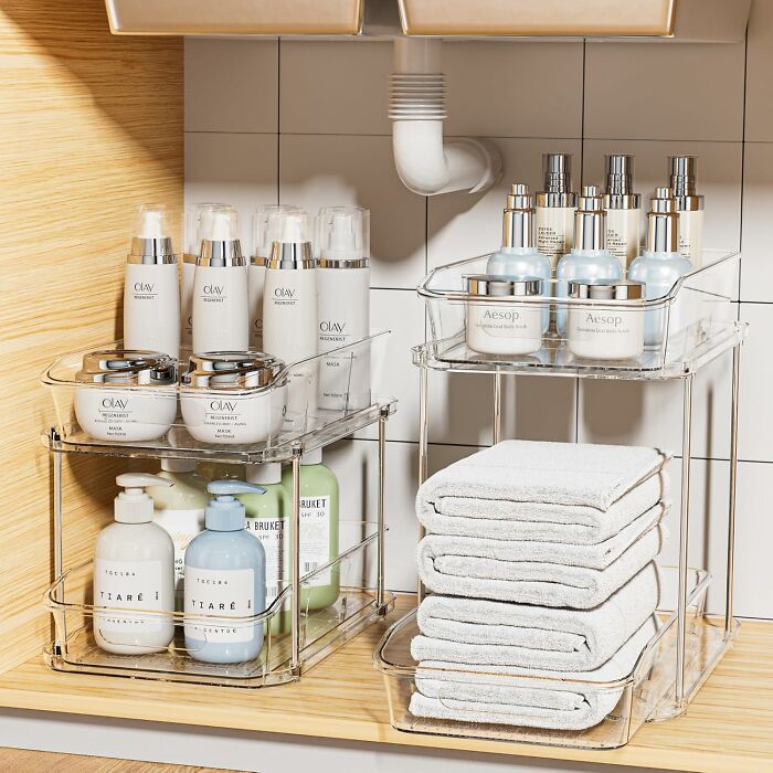 Clear acrylic organizers neatly storing skincare products and towels showcasing Prime Day home deals.