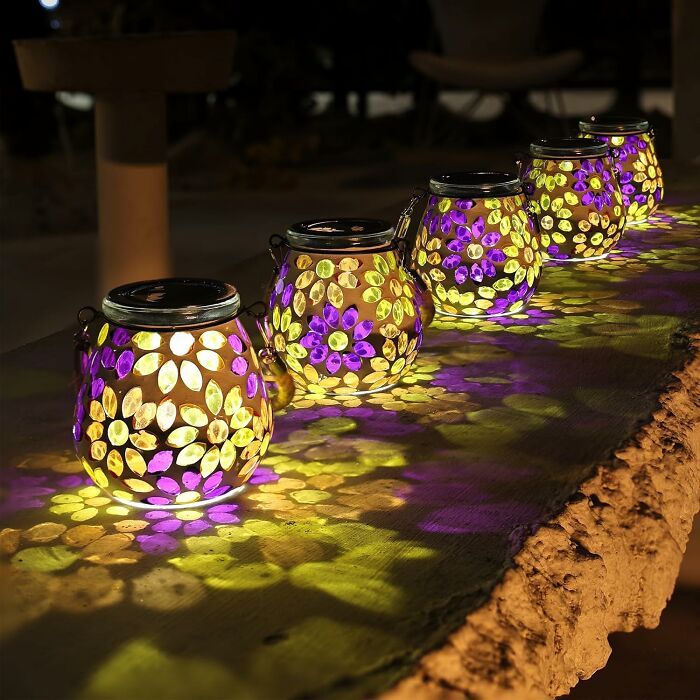 Decorative glowing lanterns casting colorful leafy patterns, perfect arty finds for inspiring your creative spirit.