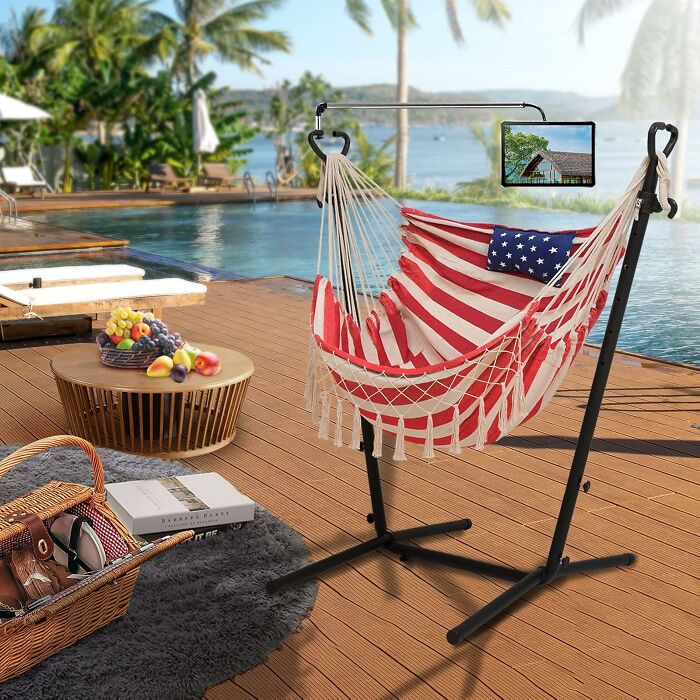 Backyard setup with American flag hammock and tablet holder by the pool, perfect for July 4th parties.