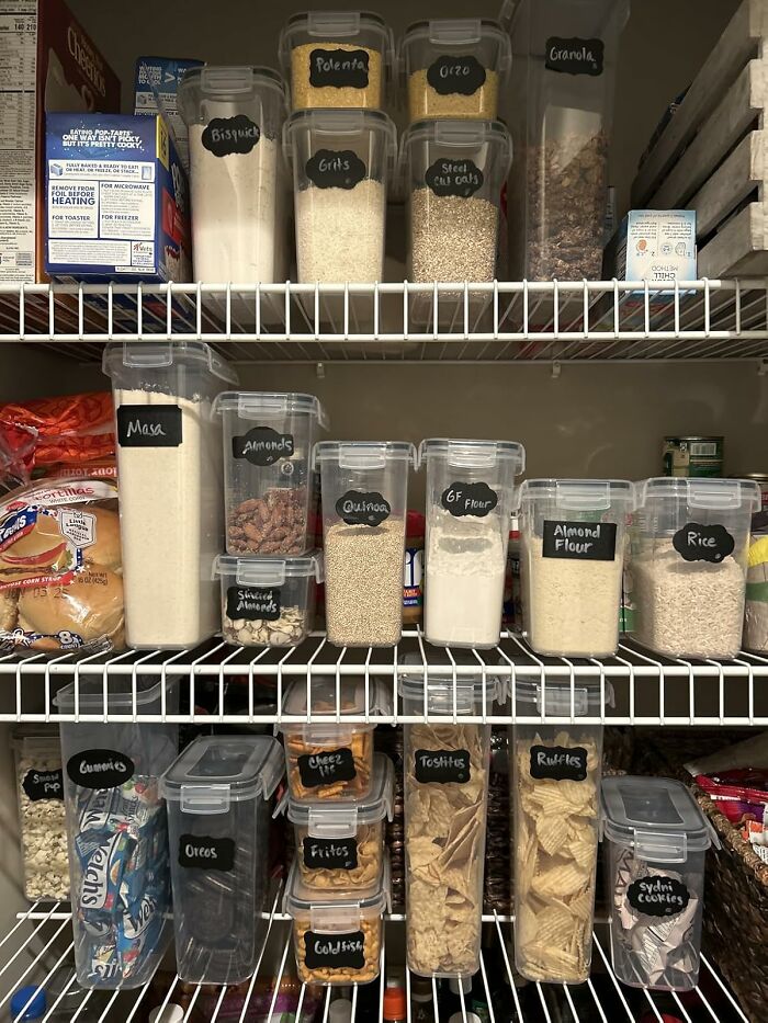 Pantry shelves organized with labeled containers holding grains, nuts, snacks, and baking essentials for easy access and storage.