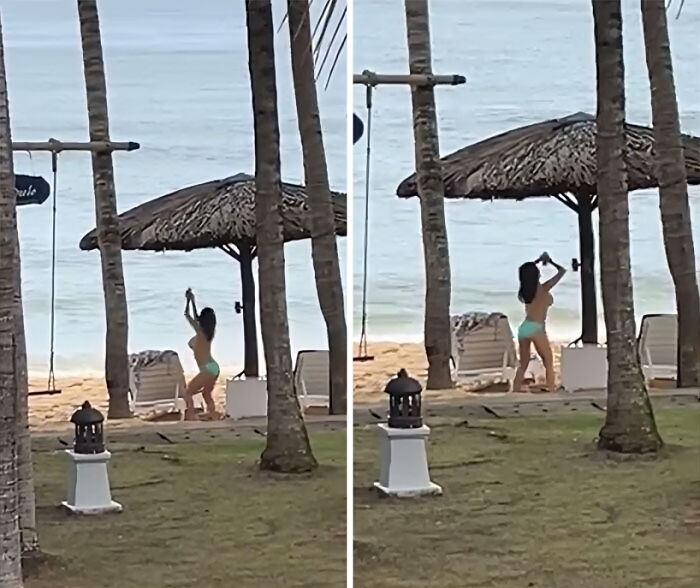 Influencer in a turquoise swimsuit taking videos at the beach under palm trees and a thatched umbrella.