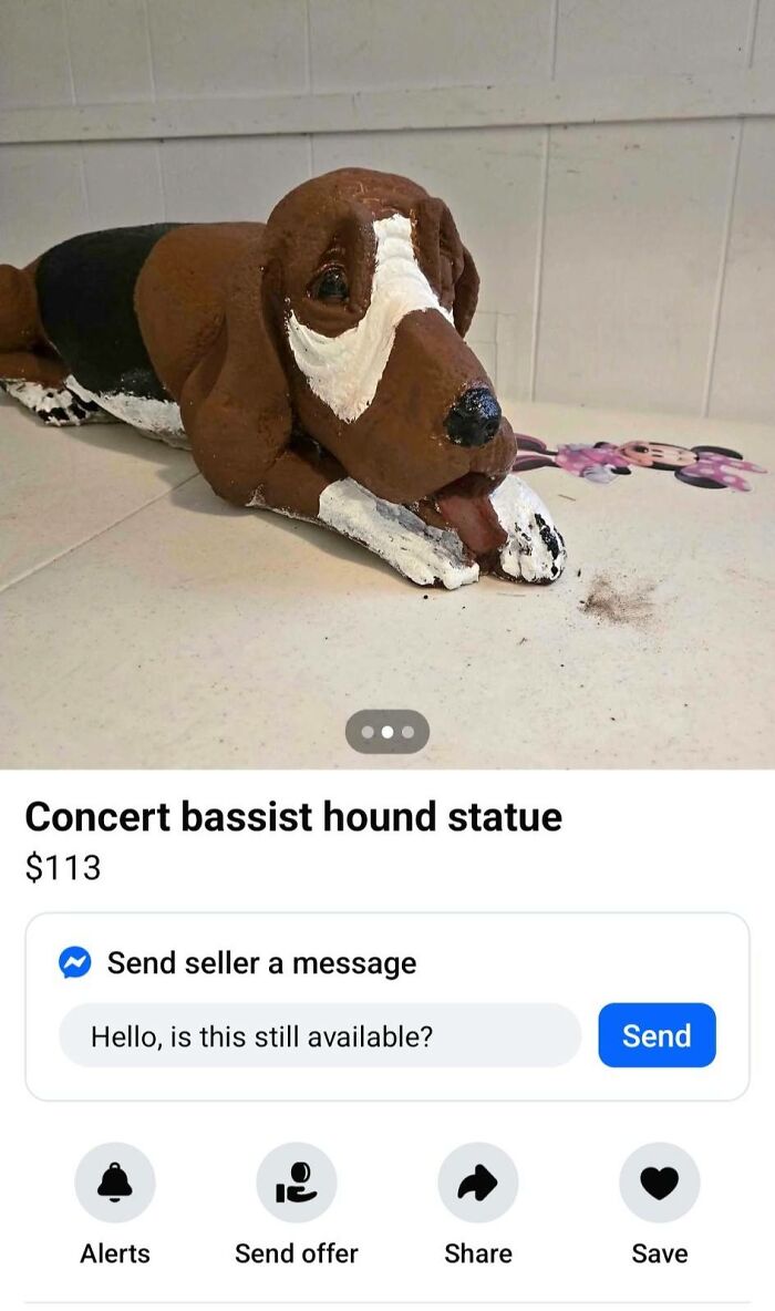 Hand-painted DIY hound statue lying on a table, showcasing a humorous and horrendous craft project for craft shaming.