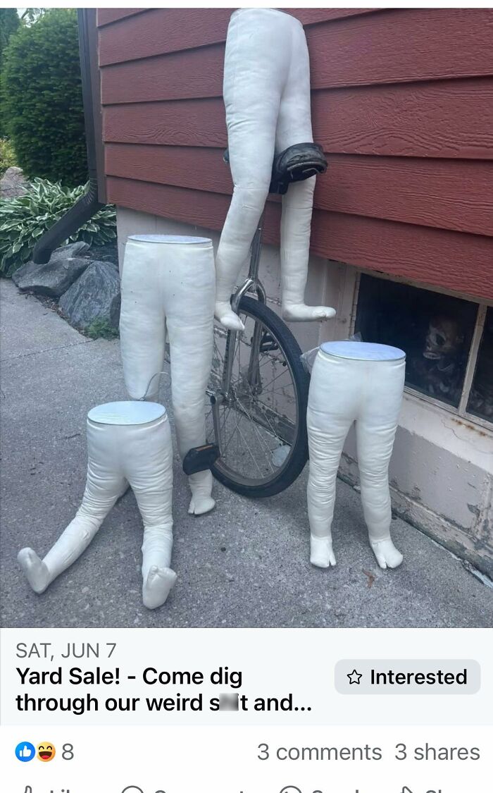 Unicycle surrounded by four craft-shaming DIY project mannequin legs outside a building.