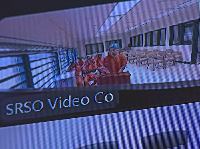 Surveillance footage showing captive woman in orange jumpsuit during rescue after brave cry for help at Jersey Mike's restroom.