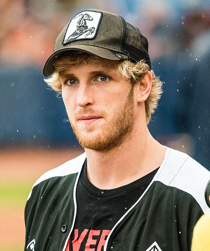 Young man wearing a black cap and sports jersey, representing famous people who did evil things ignored by the world.
