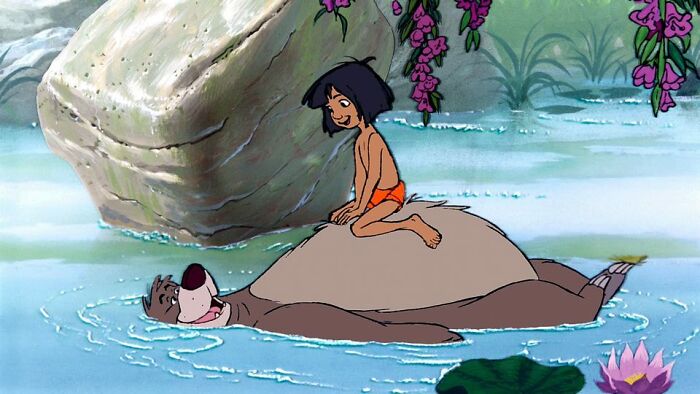 Animated scene of a boy and bear relaxing in a forest pond, connecting with nature and friendship moments.