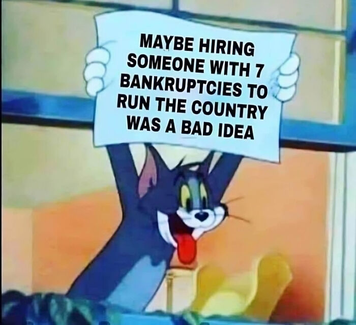 Tom cartoon cat holding a sign with a powerful meme about hiring failures, shared by a Facebook group.