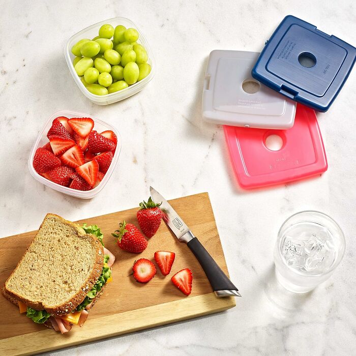 Reusable containers, fresh fruit, and a sandwich prepared for an al fresco feast on International Picnic Day.