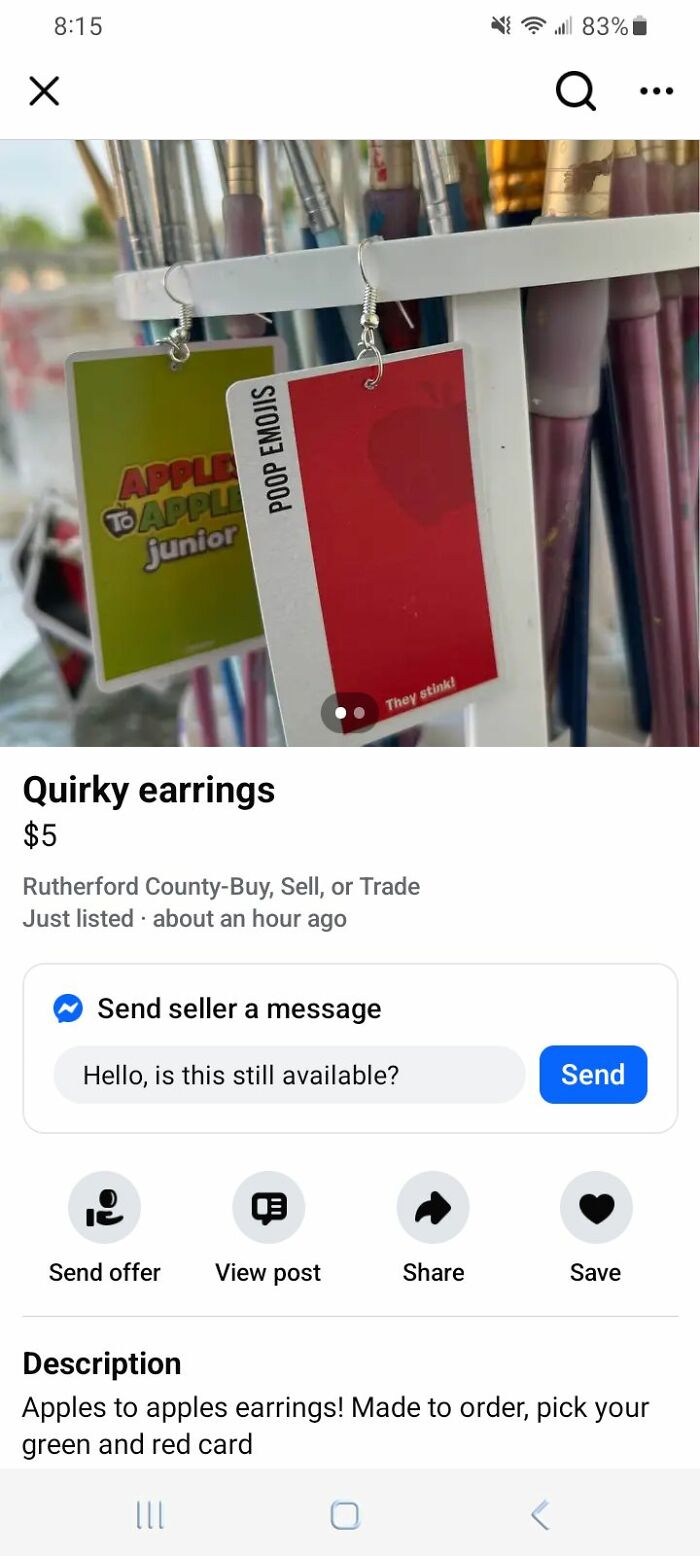 Earrings made from quirky DIY apples to apples game cards hanging on a paintbrush holder for craft shaming projects.