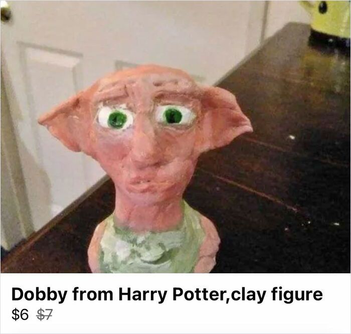 Clumsy handmade clay figure of Dobby from Harry Potter displayed on a dark wooden surface, showcasing horrible crafts.