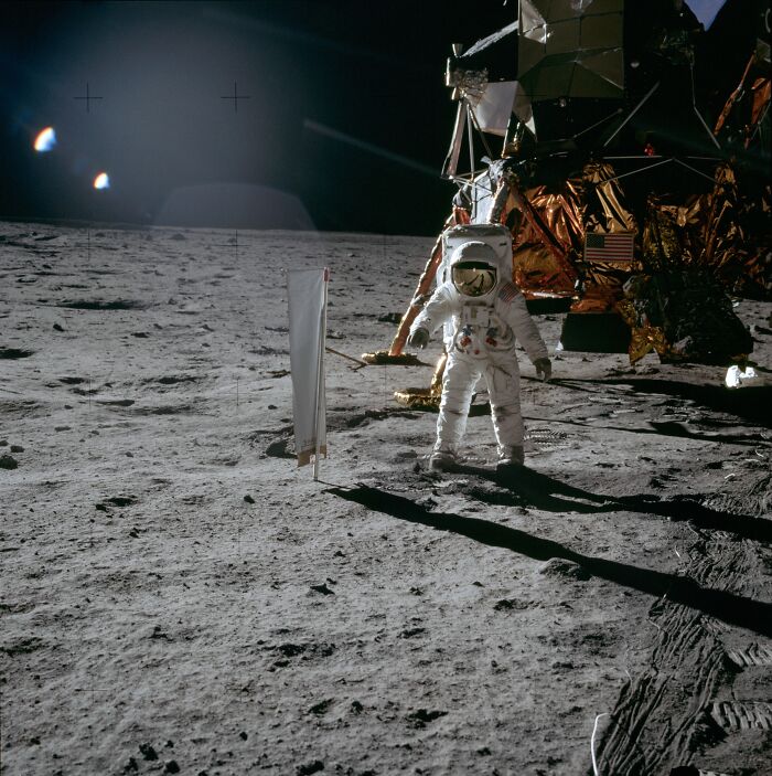 Astronaut on the lunar surface near the Apollo lunar module during an Apollo mission moonwalk.