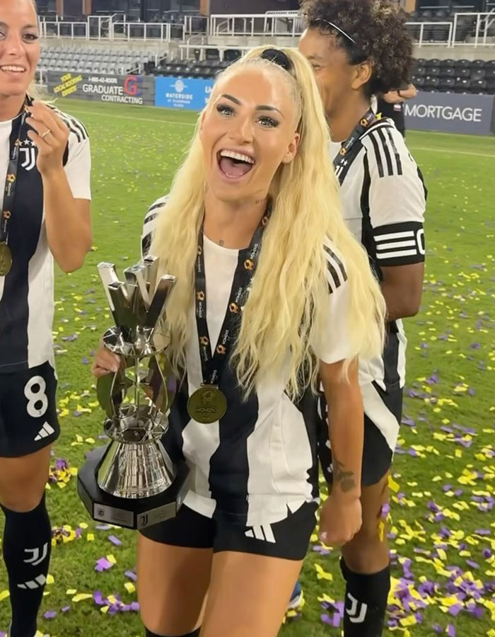 Female national soccer team celebrating with trophy on field after U15 boys team defeat, sparking hilarious reactions. Female national soccer team celebrating with trophy on field after U15 boys team defeat, sparking hilarious reactions.