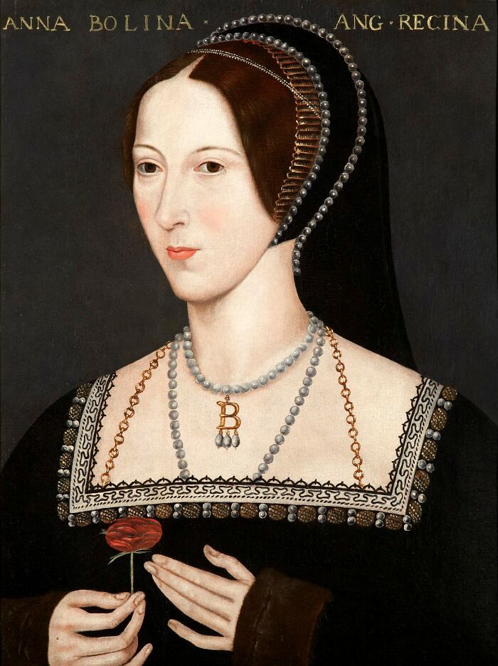 Portrait of Anne Boleyn holding a red flower, showcasing famous names from history known for being good looking.