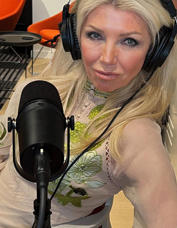 Woman wearing headphones speaking into a microphone in a recording studio, related to anti-vax mom claims and cancer. Woman wearing headphones speaking into a microphone in a recording studio, related to anti-vax mom claims and cancer.